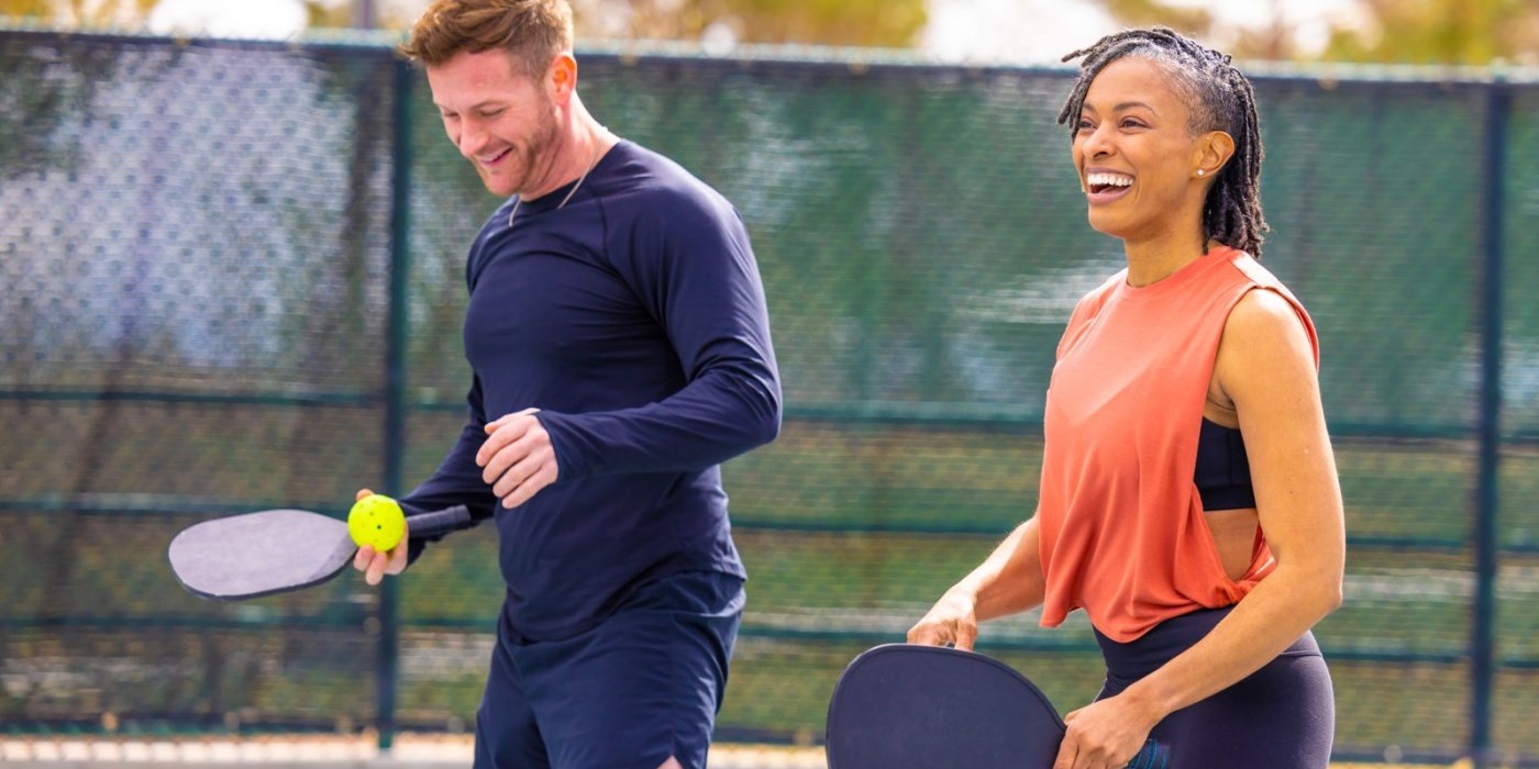 a man and woman playing pickleball
